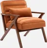 A single terrakotta colored armchair with wooden legs and frame, with a small pillow on it, against a white background. Produktbild-Vorschau