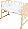 A baby crib with bedding, set against a white background. Produktbild-Vorschau