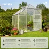 A greenhouse in a garden setting, surrounded by plants and grass, with informational text overlays at the bottom. Náhled obrázku produktu