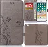 A collage of images showing a grey flip phone case with a floral design, a smartphone inside the case, and the case from the back. Produktbild-Vorschau