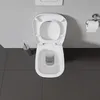 A top-down view of a white toilet with the lid open, situated on a dark gray tiled floor against a light gray wall. Produktbild-Vorschau