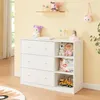 A white dresser with shelves, filled with baby items and toys, in a nursery or child's room. Podgląd zdjęcia produktu