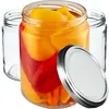 Three glass jars, one filled with red and yellow peppers, and a silver lid. Produktbild-Vorschau