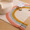 A child's chair and a rainbow rug with wooden toys and books on it. Náhľad obrázku produktu
