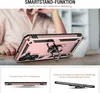 A person's hands are visible behind a rose gold phone case with a ring stand, displayed on a table. Produktbild-Vorschau