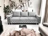 A modern living room setting with a sofa, coffee table, and artwork. Produktbild-Vorschau