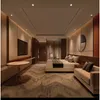 A modern hotel room with a bed, sofa, TV, and a small table. Produktbild-Vorschau