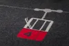 A close-up of a blanket with a graphic of a ski lift gondola. Produktbild-Vorschau