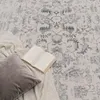 A rug with a book and pillow on it. Anteprima dell’immagine prodotto
