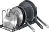 A black metal rack holding several pots and pans. Anteprima dell’immagine prodotto