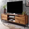 A modern wooden TV stand with a television on top, placed in a living room setting with a textured wall and a rug on the floor. Produktbild-Vorschau