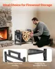 A man is placing firewood into a black metal firewood rack next to a stone fireplace. Produktbild-Vorschau
