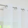 Close-up of white sheer curtains hanging from a metal rod. Produktbild-Vorschau
