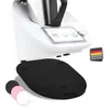 A close-up of a kitchen appliance with a mat underneath and smaller mats in the foreground. Produktbild-Vorschau