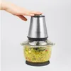 A hand is pressing down on the lid of a food chopper filled with chopped ingredients. Produktbild-Vorschau