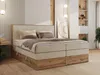 A bedroom scene featuring a large boxspring bed. Produktbild-Vorschau