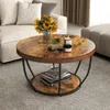 A round coffee table with a wooden top and black metal legs, decorated with sunflowers, candles, and books, placed in a living room setting. Anteprima dell’immagine prodotto