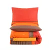 A stack of folded bedding with a pillow on top, all with a paisley and striped pattern. Anteprima dell’immagine prodotto