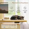 A tabby cat is sleeping on a desk next to a computer monitor, with infographics about the desk's features overlaid. Podgląd zdjęcia produktu