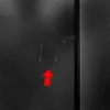 A close-up of a black surface with scratches, marked by a red arrow. Produktbild-Vorschau