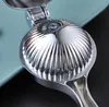 A close-up of a shiny metal citrus juicer. Produktbild-Vorschau