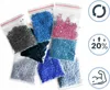 Multiple small plastic bags filled with colorful beads, likely for diamond painting, arranged on a white background. Icons for recycling, 20% increase, and a muscular arm are on the right side. Podgląd zdjęcia produktu
