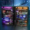 A diorama-style computer case with intricate mechanical and futuristic elements, illuminated by colorful LEDs. Podgląd zdjęcia produktu