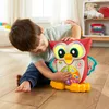 A young boy is playing with a toy owl on the floor. Náhled obrázku produktu
