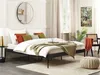 A bedroom scene with a bed, pillows, blankets, and decorative items. Náhľad obrázku produktu