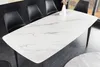 A dining table with chairs in a modern setting. Produktbild-Vorschau