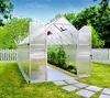 A greenhouse in a backyard setting with a white picket fence and trees. Produktbild-Vorschau