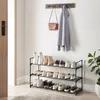 An entryway with a shoe rack, coat rack, and a plant. Produktbild-Vorschau