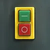 A close-up of a green and red button on a yellow panel. Podgląd zdjęcia produktu