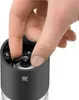 A hand is shown adjusting a part of a black electric salt and pepper grinder. Produktbild-Vorschau