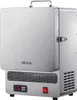 A silver VEVOR tabletop melting furnace is shown from a front-side angle against a white background. The lid is partially open, revealing a glimpse of the interior. The furnace has a digital display and a red power switch on the front. Podgląd zdjęcia produktu