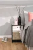 A bedroom scene with a nightstand next to a bed. Náhľad obrázku produktu