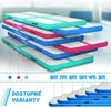 A stack of colorful inflatable air mats in a gym setting. Podgląd zdjęcia produktu