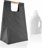 A dark grey laundry bag with a wooden handle and a white bottle of laundry detergent are shown against a white background. Produktbild-Vorschau