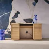 A modern wooden desk with a book and a decorative sculpture on top, set against a striking abstract wallpaper. Produktbild-Vorschau