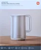 The image shows the packaging of a Xiaomi Double Wall Electric Kettle, with the kettle itself prominently displayed on a wooden surface. Náhľad obrázku produktu