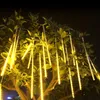 Yellow meteor shower string lights hanging from a tree at night. Produktbild-Vorschau