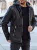 A man wearing a black leather jacket and jeans, standing in front of a white car. Voir les images du produit