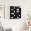 A black display cabinet mounted on a white wall, filled with various decorative items. Produktbild-Vorschau