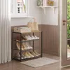 An entryway with a shoe rack, bags, and a rug. Produktbild-Vorschau