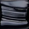 A close-up abstract shot of a dark, viscous liquid with ripples and reflections. Produktbild-Vorschau