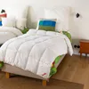 Two beds with white duvets and pillows in a room. Produktbild-Vorschau