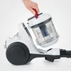 A person's hand is shown detaching the dustbin from a white and gray cyclonic vacuum cleaner. Anteprima dell’immagine prodotto