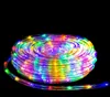 A coiled rope light with multicolor LEDs against a black background. Produktbild-Vorschau
