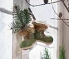 Decorative ice skates hanging in a window with pine branches. Produktbild-Vorschau
