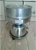 A stainless steel electric vibrating sieve machine is shown on a wooden floor, with cardboard boxes in the background. Náhled obrázku produktu